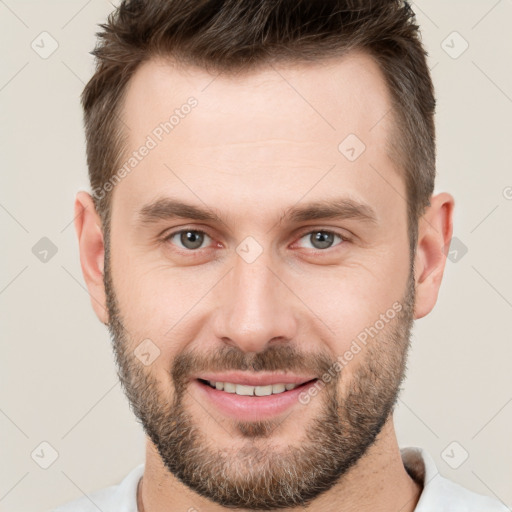 Joyful white young-adult male with short  brown hair and brown eyes