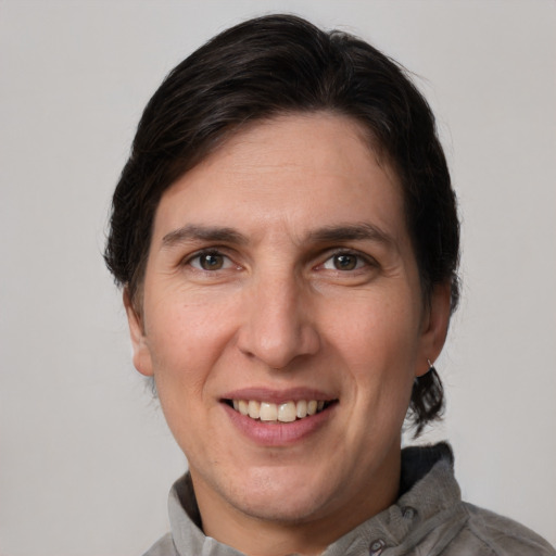 Joyful white adult female with medium  brown hair and grey eyes