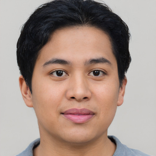 Joyful asian young-adult male with short  brown hair and brown eyes