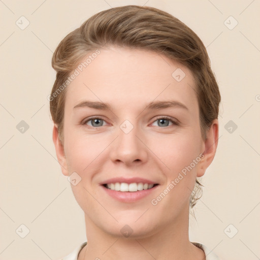 Joyful white young-adult female with short  brown hair and grey eyes