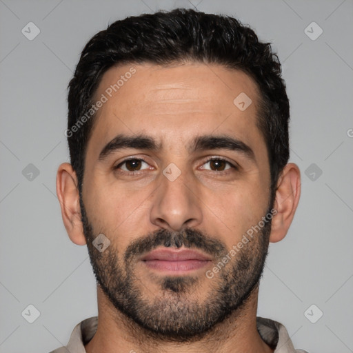 Joyful white young-adult male with short  black hair and brown eyes