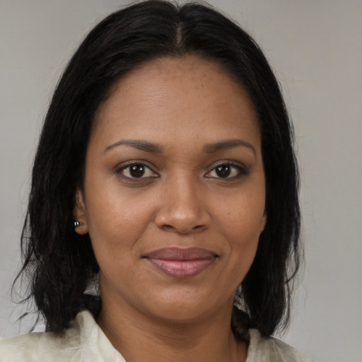 Joyful black young-adult female with medium  brown hair and brown eyes