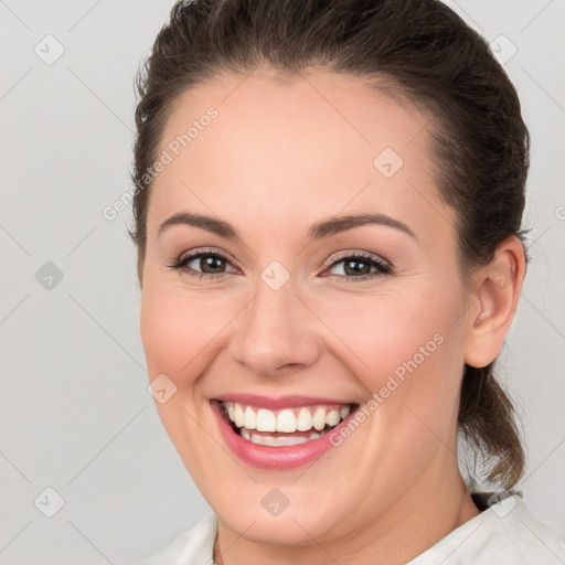 Joyful white young-adult female with medium  brown hair and brown eyes