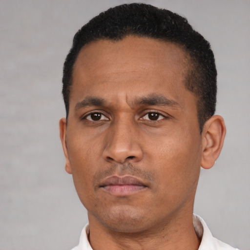 Neutral latino adult male with short  black hair and brown eyes