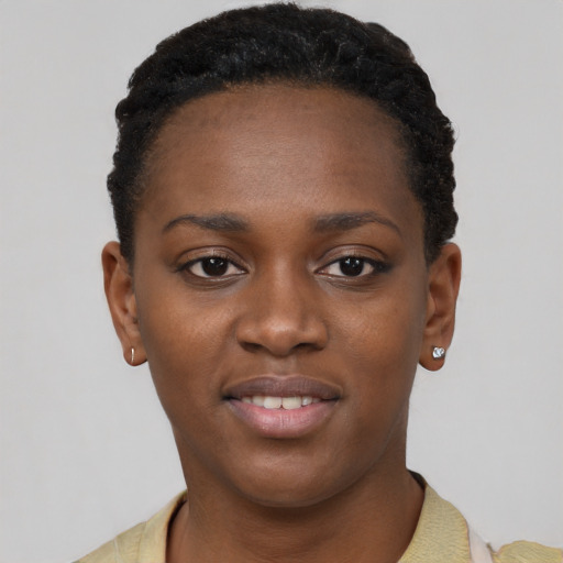 Joyful black young-adult female with short  black hair and brown eyes