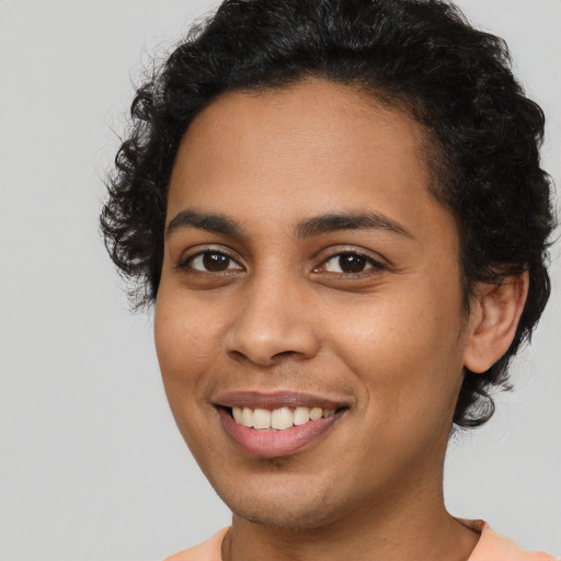 Joyful latino young-adult female with short  brown hair and brown eyes