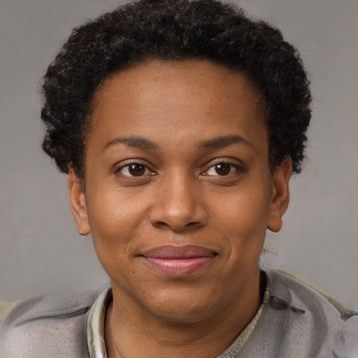 Joyful black young-adult female with short  brown hair and brown eyes