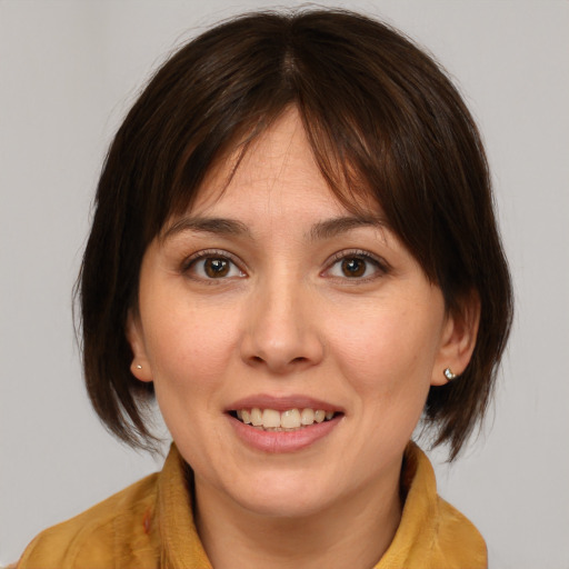 Joyful white young-adult female with medium  brown hair and brown eyes