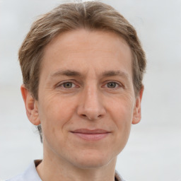 Joyful white adult male with short  brown hair and grey eyes