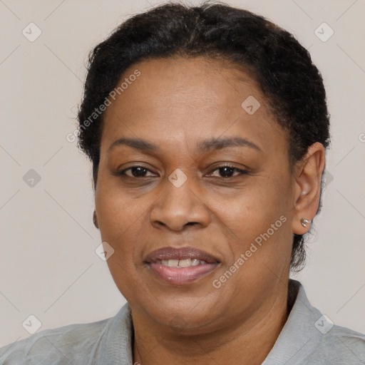 Joyful black adult female with short  brown hair and brown eyes