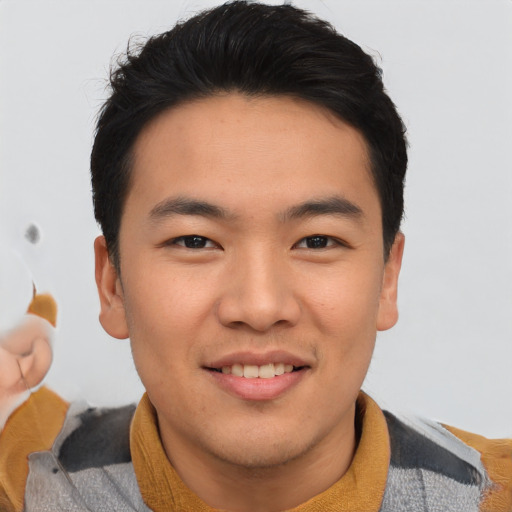 Joyful asian young-adult male with short  brown hair and brown eyes