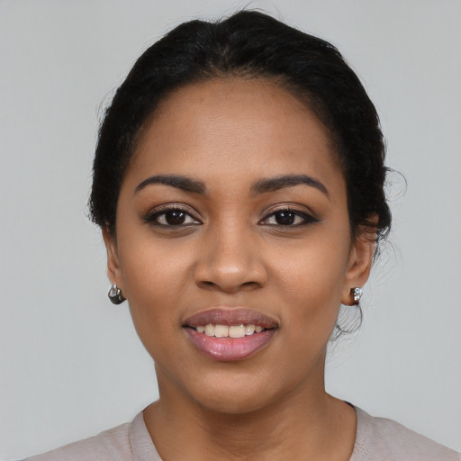 Joyful latino young-adult female with short  black hair and brown eyes