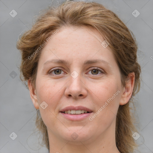 Joyful white adult female with medium  brown hair and blue eyes