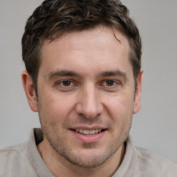 Joyful white young-adult male with short  brown hair and brown eyes