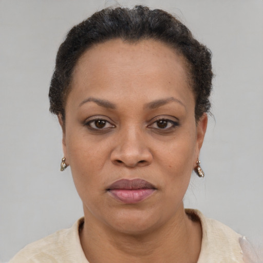 Joyful black adult female with short  brown hair and brown eyes