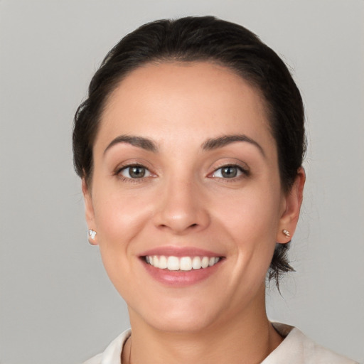 Joyful white young-adult female with short  brown hair and brown eyes