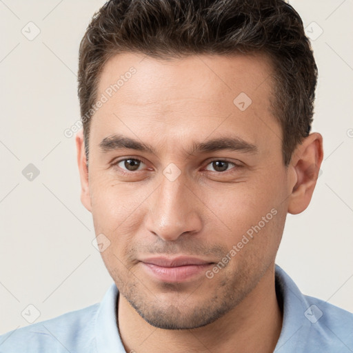 Joyful white young-adult male with short  brown hair and brown eyes