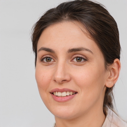 Joyful white young-adult female with medium  brown hair and brown eyes