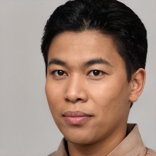 Joyful asian young-adult male with short  black hair and brown eyes