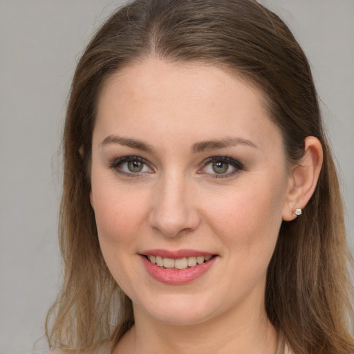 Joyful white young-adult female with long  brown hair and grey eyes