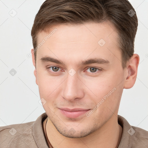 Joyful white young-adult male with short  brown hair and grey eyes