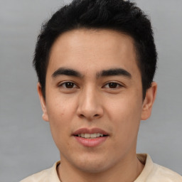 Joyful asian young-adult male with short  brown hair and brown eyes