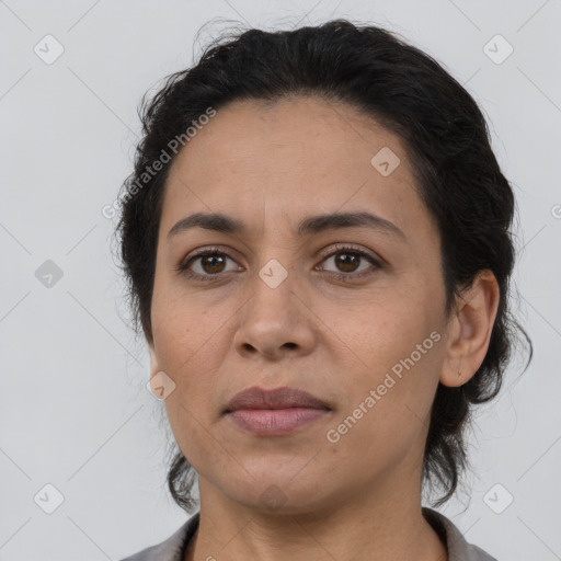 Joyful latino adult female with short  brown hair and brown eyes