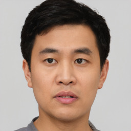 Neutral asian young-adult male with short  black hair and brown eyes