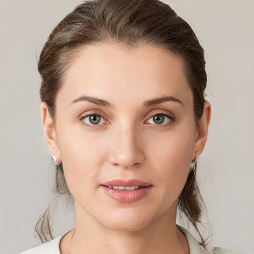 Joyful white young-adult female with medium  brown hair and grey eyes