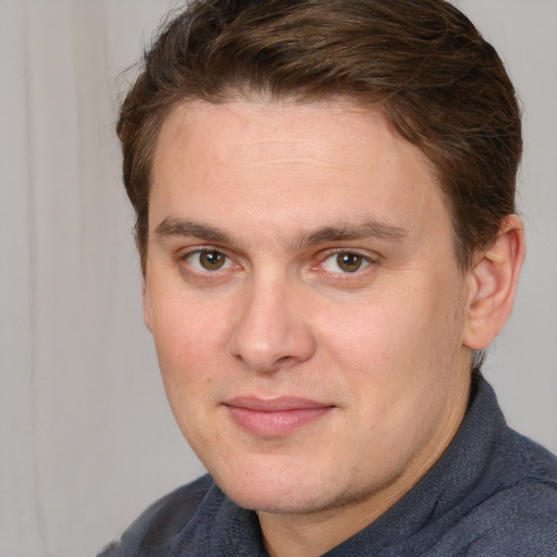 Joyful white adult male with short  brown hair and grey eyes