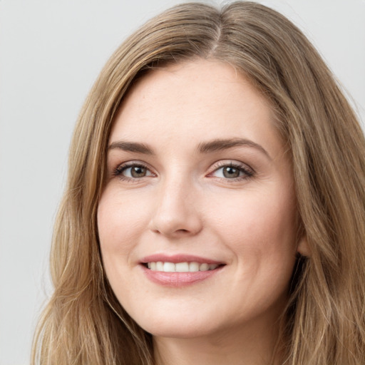 Joyful white young-adult female with long  brown hair and green eyes