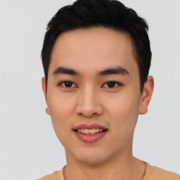 Joyful asian young-adult male with short  black hair and brown eyes