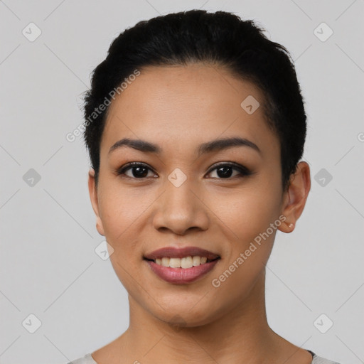 Joyful latino young-adult female with short  black hair and brown eyes