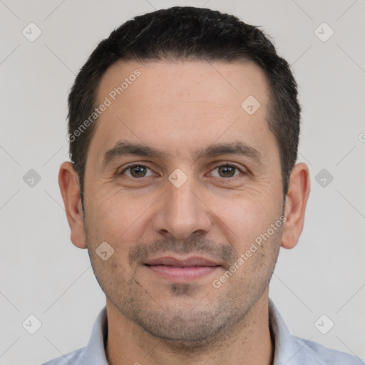 Joyful white adult male with short  black hair and brown eyes