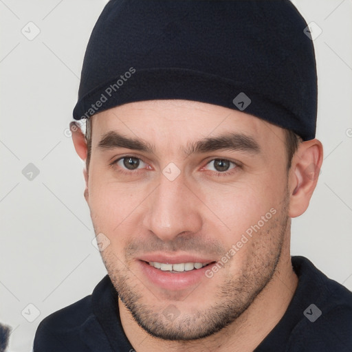 Joyful white young-adult male with short  brown hair and brown eyes