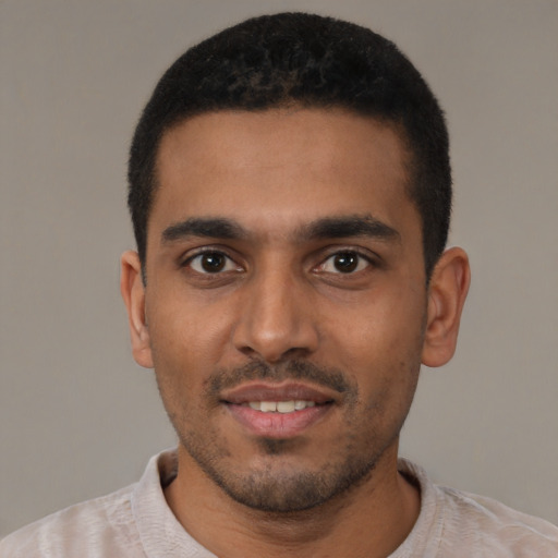 Joyful latino young-adult male with short  black hair and brown eyes