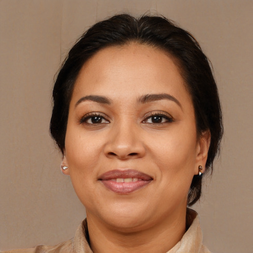Joyful latino adult female with medium  brown hair and brown eyes