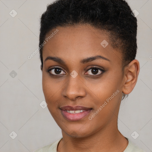 Joyful black young-adult female with short  brown hair and brown eyes