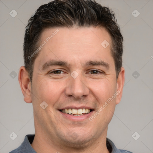 Joyful white adult male with short  brown hair and brown eyes