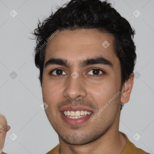 Joyful latino young-adult male with short  black hair and brown eyes