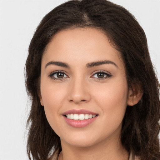 Joyful white young-adult female with long  brown hair and brown eyes