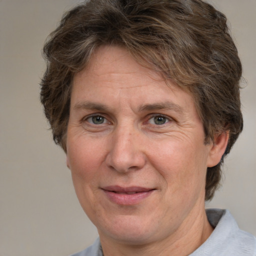 Joyful white adult male with medium  brown hair and brown eyes