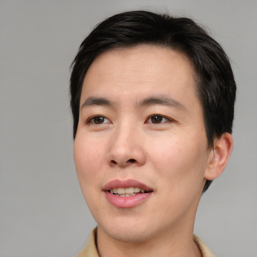 Joyful asian young-adult male with short  brown hair and brown eyes