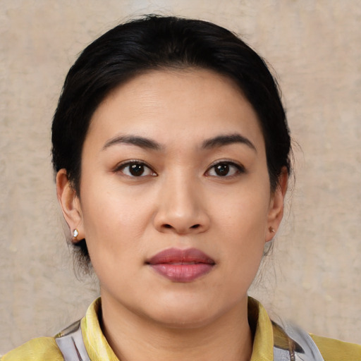 Joyful asian young-adult female with medium  black hair and brown eyes
