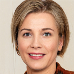 Joyful white adult female with medium  brown hair and grey eyes