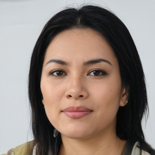 Joyful asian young-adult female with long  black hair and brown eyes