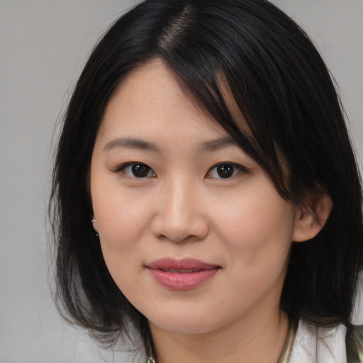 Joyful asian young-adult female with medium  brown hair and brown eyes