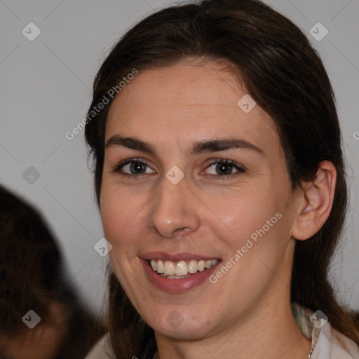 Joyful white adult female with medium  brown hair and brown eyes