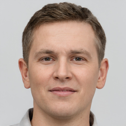 Joyful white adult male with short  brown hair and grey eyes