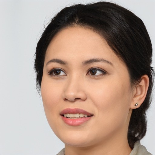 Joyful asian young-adult female with medium  brown hair and brown eyes